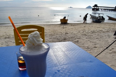 Whipped cream on top of a coconut shake? Why not? Waiting for sunset on Coral Bay. Photo by: Stuart McDonald.