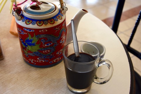 Jasmine tea alongside a cup of famed Trang coffee, or <i>kopi</i>. Photo by: David Luekens.