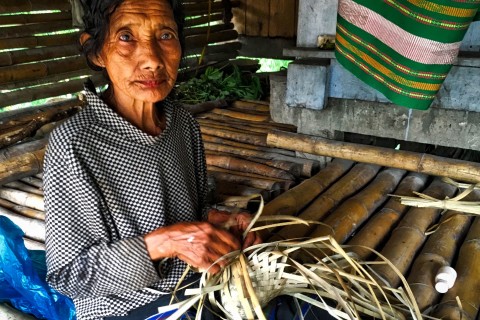 An elder weaves a basket at Prai Ijing village. Photo by: Sally Arnold.
